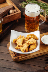 Plate of fried chebureks meat stuffed pies on wooden background