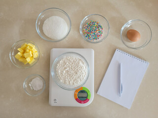 6 bowl of ingredients, notepad and pen, digital kitchen scale