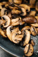 Closeup of sauteed cremini mushrooms in a frying pan