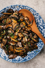 Fototapeta premium Plate of sautéed cremini mushrooms