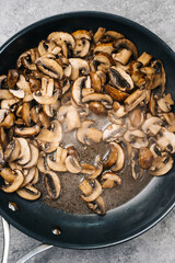 Overhead photo of sauteed cremini mushrooms with steam