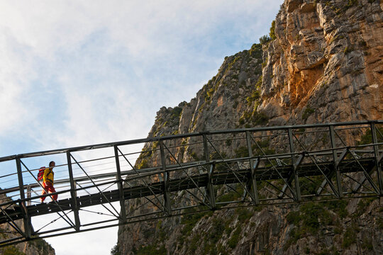 female hiker crossing steal bridge in the Verdon canyon
