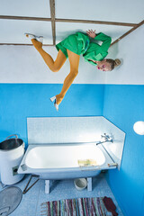 Woman wearing bright clothes laying at the ceiling and looking at her leg