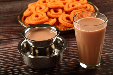 Indian milk tea, masala chai served with spicy snacks.