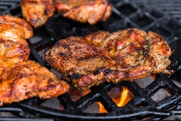 Fresh grilled meat. Preparing meat on the grill. Close-up view of a hot grill with meat.