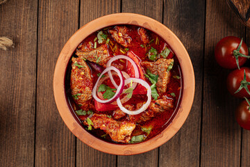 Georgian dish chakhokhbili stewed chicken in a clay bowl