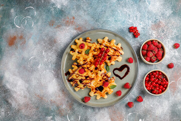 Homemade waffles with raspberries and red currants.