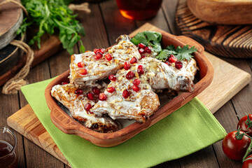 Georgian dish chkmeruli chicken with garlic cream and pomegranate