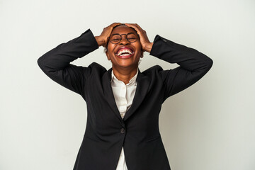 Young business african american woman isolated on white background laughs joyfully keeping hands on head. Happiness concept.