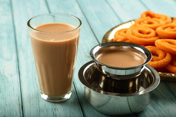 Indian milk tea- masala chai served with snack foods