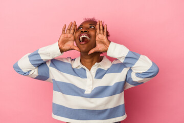 Young african american woman isolated on pink background shouting excited to front.
