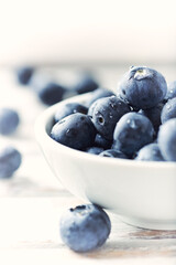 Bilberries on bright wooden background. Close up. 