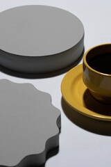 yellow coffee cup with gray geometric figures on wood