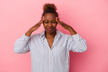 Young african american woman isolated on pink background having a head ache, touching front of the face.