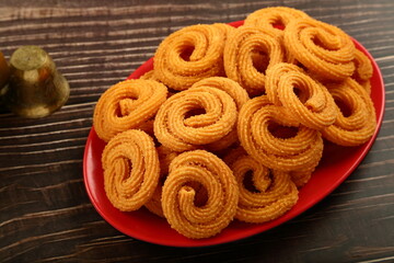 Homemade savory snack foods- murukku, chakli, chakli, spicy Indian snack foods.