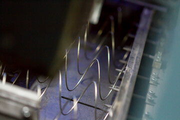 Production of independent springs for mattresses. Independent spring blocks packed in spunbond. Coiling and hardening of springs. Furniture manufacture. Industrial and business concept.