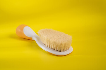 Comb baby's hair on a yellow background