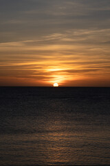 Naklejka na ściany i meble Sunset in Ibiza, sun goes down into the sea, Spain