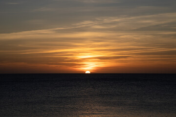 Fototapeta premium Sunset in Ibiza, sun goes down into the sea, Spain