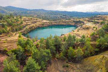 Restoration of former open pit copper mining area near Kapedes, Cyprus with forest restored over old waste dumps