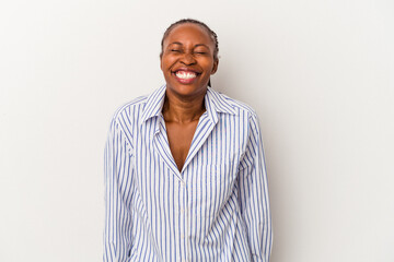 Young african american woman isolated on white background laughs and closes eyes, feels relaxed and happy.