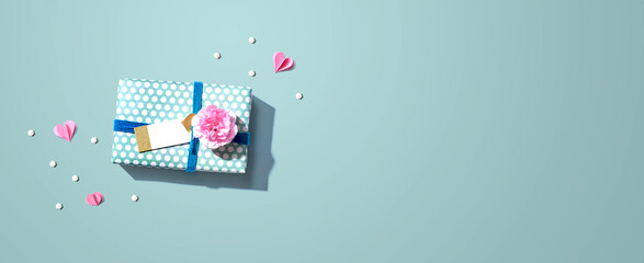 Gift box with a pink carnation flower