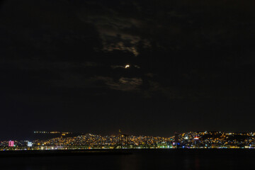 Fototapeta na wymiar night sky , city , sea and full moon