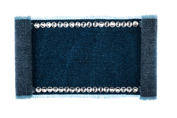 Denim sign embellished with silver rhinestones with curled edges. Isolated
