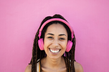 Bohemian african girl listen playlist music with headphones - Focus on face