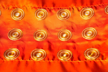 Texture, background, pattern. Texture of orange silk. Beautiful soft emerald orange silk.