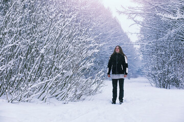 Bearded man in the winter woods. Attractive happy young man with beard walk in the park.