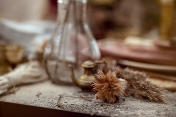 A table  designed for a boho style event with an eucalyptus, vintage plates and other rustic touches. On seaside in the sand dunes