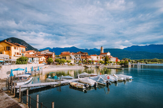 Feriolo, Verbania / Italy - June 2021: Feriolo village on Lake Maggiore with cloudy sky with small boats moored in the foreground