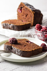chocolate cake with raspberries on a plate