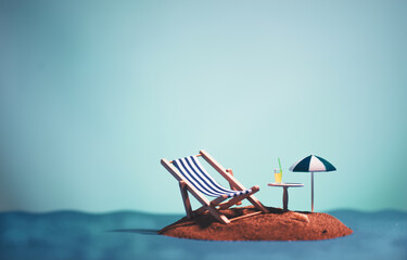 Still life shot of an island with an umbrella,one sunbed, a table and a drink on it.