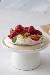 Pavlova cake with berries and cream