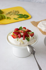 Pavlova cake with berries and cream