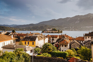 Fototapeta premium Orta San Giulio / Italy - June 2021: View of the Island of San Giulio (Lake Orta), from the road that leads to the historic center of the town