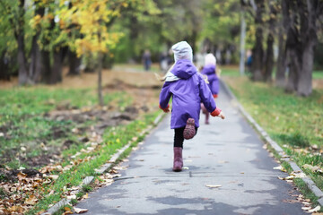 Leaf fall in the park. Children for a walk in the autumn park. Family. Fall. Happiness.