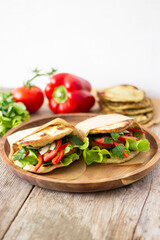 Healthy vegan sandwich with fresh vegetables and a vegan burger inside