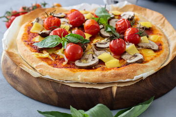 Vegan pizza with tomatoes and mushrooms