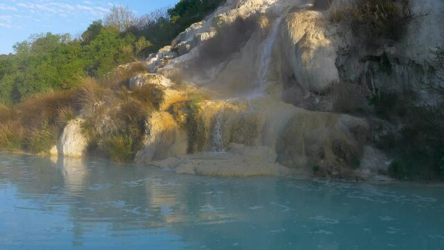 Geothermal pool and hot spring in Tuscany, Italy. Bagno Vignoni natural thermal waterfall in the morning with no people.