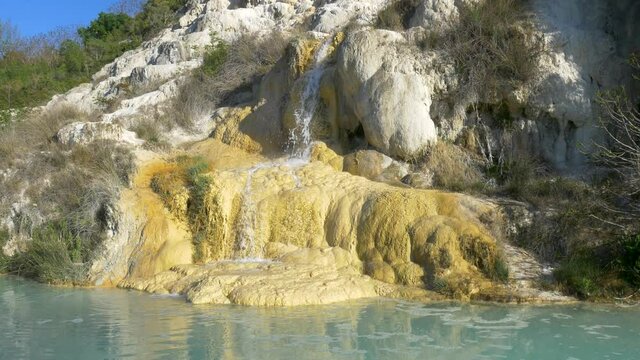 Geothermal pool and hot spring in Tuscany, Italy. Bagno Vignoni natural thermal waterfall in the morning with no people.