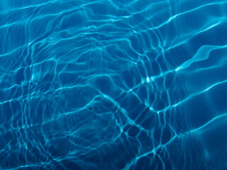 Swimming pool water surface with sparkling light reflections