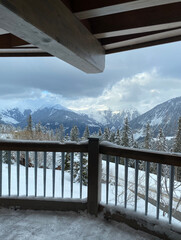 Snowy wood balcony with mountain view
