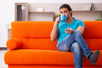 Young male student sitting indoors during pandemic