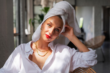 Beautiful female portrait. Woman wearing red lipstick and turban towel on head while relaxing at home.  - obrazy, fototapety, plakaty