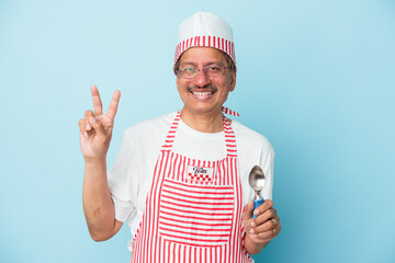 Senior indian ice cream man holding a scoop isolated on blue background showing number two with fingers.