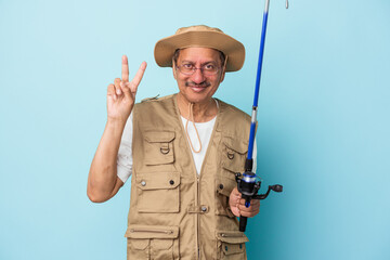 Senior indian fisherman holding rod isolated on blue background showing number two with fingers.