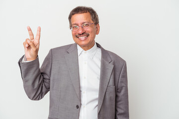 Middle aged indian business man isolated on white background joyful and carefree showing a peace symbol with fingers.